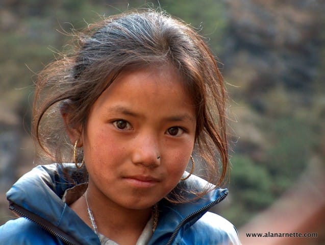 One of my all time favorite pictures from Nepal in 2002. I met this young lady and her brothers and sisters just above Namche Bazar. She looked directly into the camera, almost posing, for this shot. I wonder where she is today?
