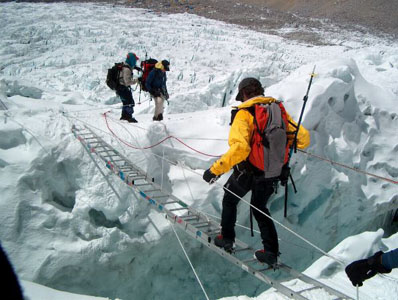 crossing a crevasse on a ladder